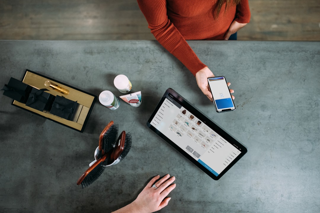 person-holding-smartphone-beside-tablet-computer-xn5fbem9564